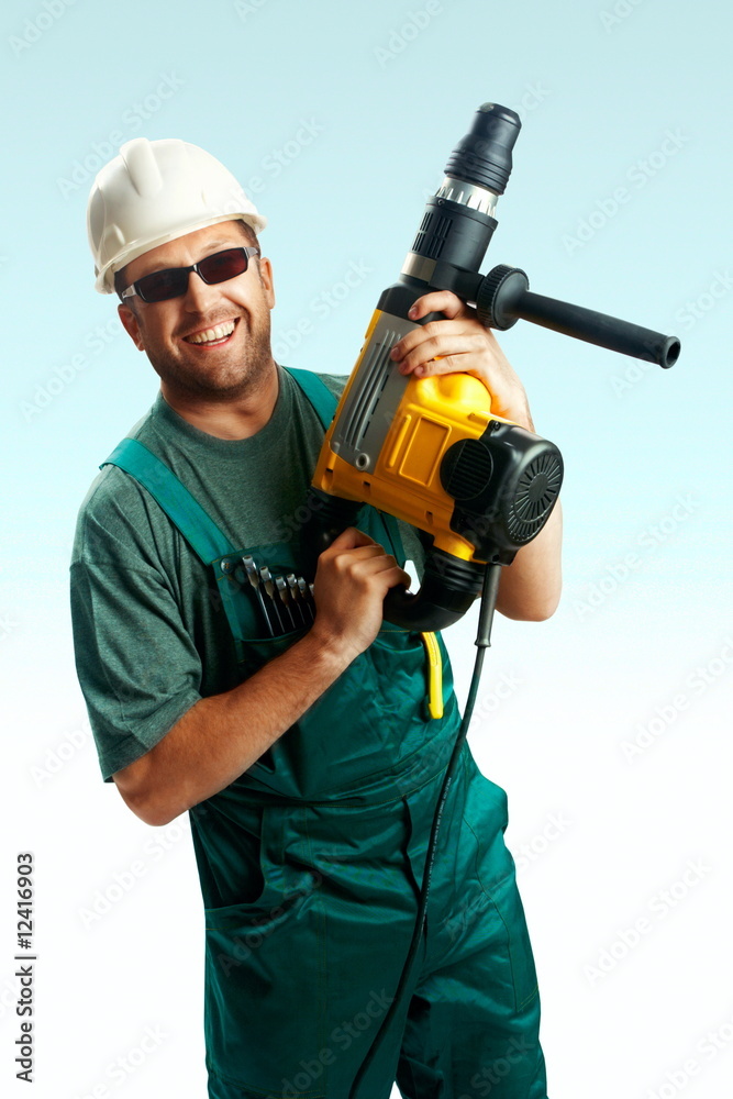 Serious skeptic workman with perforator, suitcase. over white Serious skeptic workman with perforator, suitcase. over white