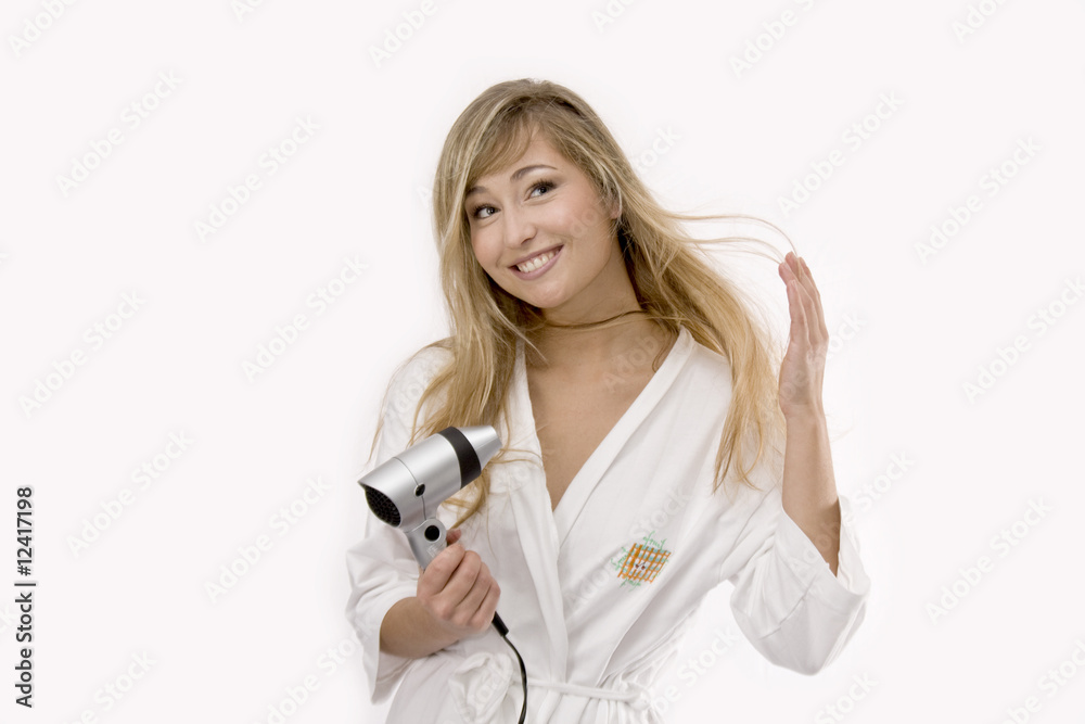young blond woman in white bathrobe with hairdryer young blond woman in white bathrobe with hairdryer