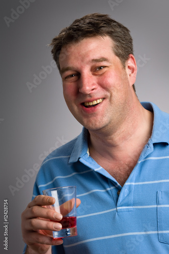 Healthy man drinking cranberry juice