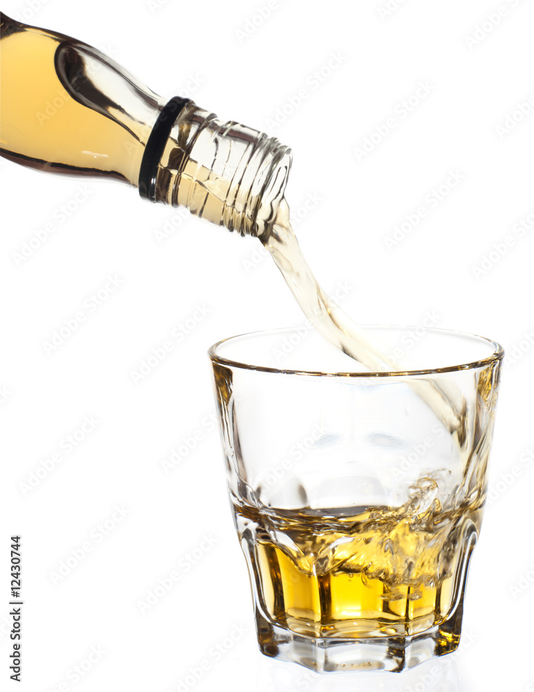 Fototapeta premium Whiskey pouring in glass, clipping path
