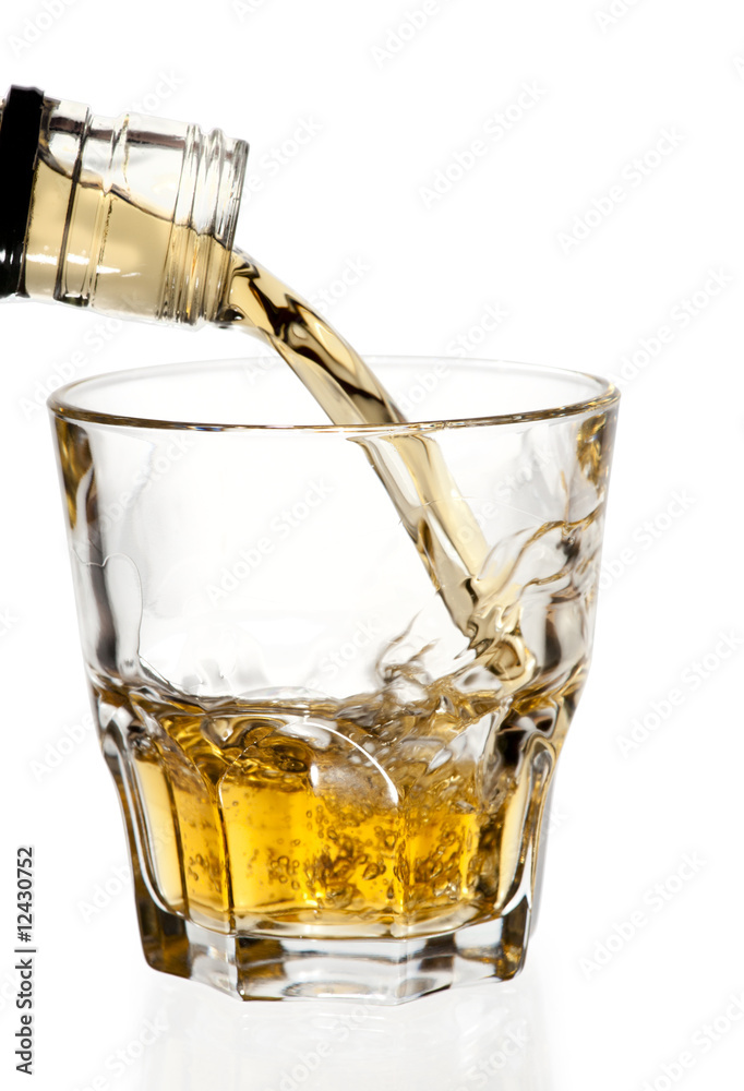 Whisky pouring in glass, isolated with clipping path Whisky pouring in glass, isolated with clipping path