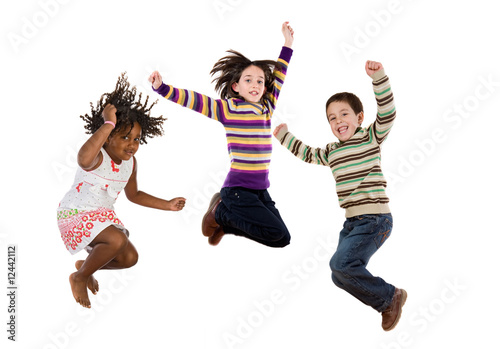 Three happy children jumping at once
