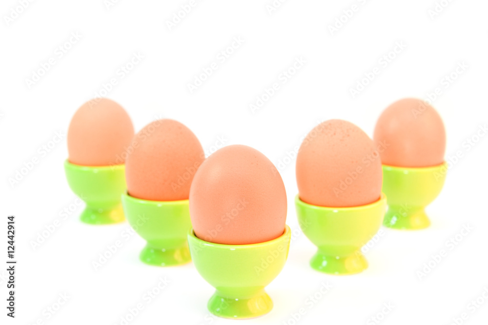 eggs in eggcups isolated on white. easter eggs in eggcups isolated on white. easter