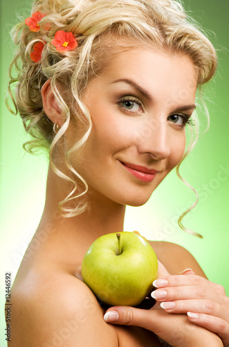 Beautiful young woman with ripe green apple