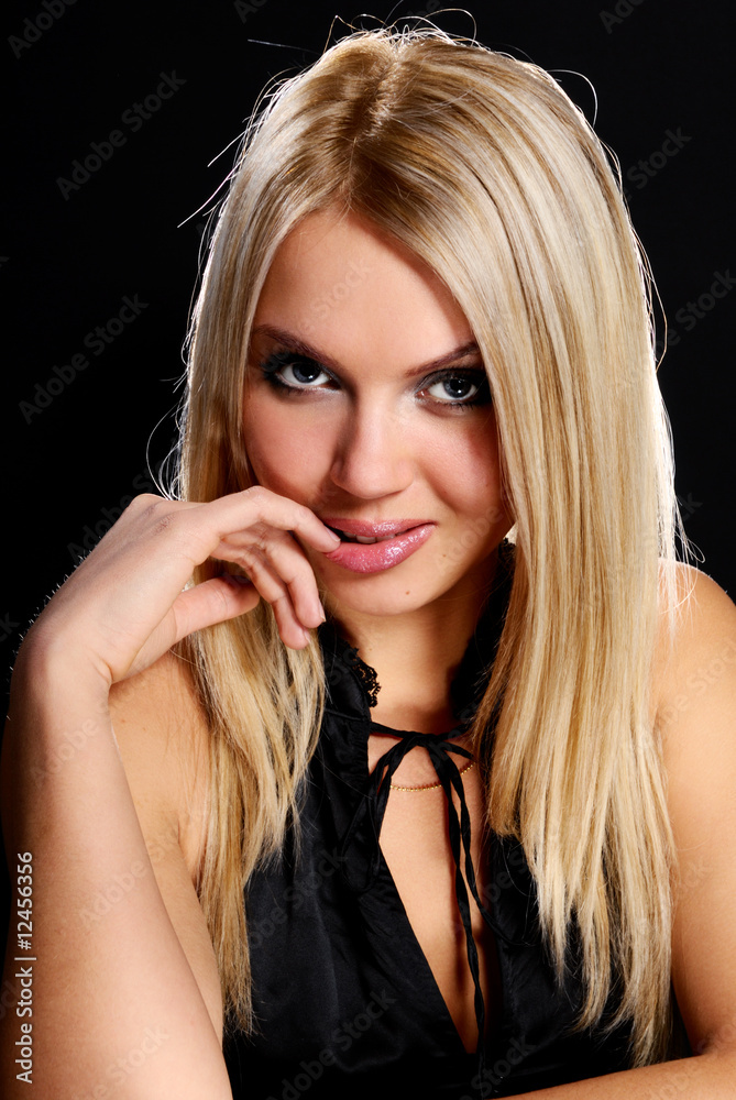 .Young beautiful blond girl on black background. .Young beautiful blond girl on black background.