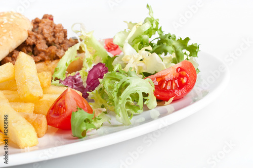 Minced meat burger with french fries and salad