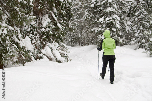 tourist in green jacket heading to the the mountains