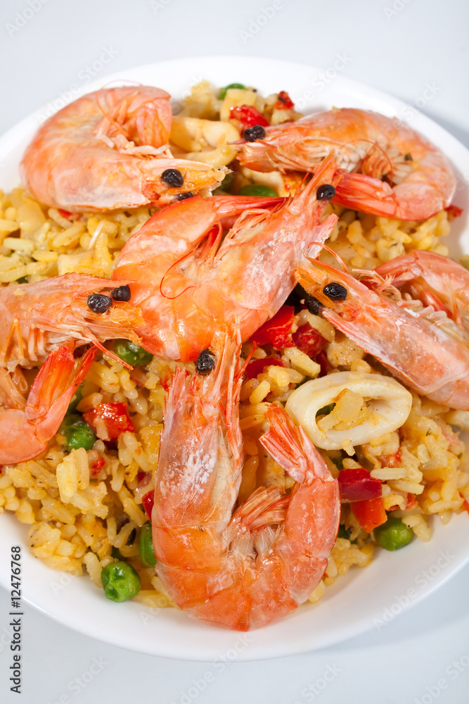 Spanish paella in a white bowl close-up