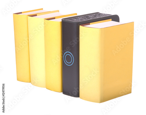 Row of yellow hardback books with a computer hard drive