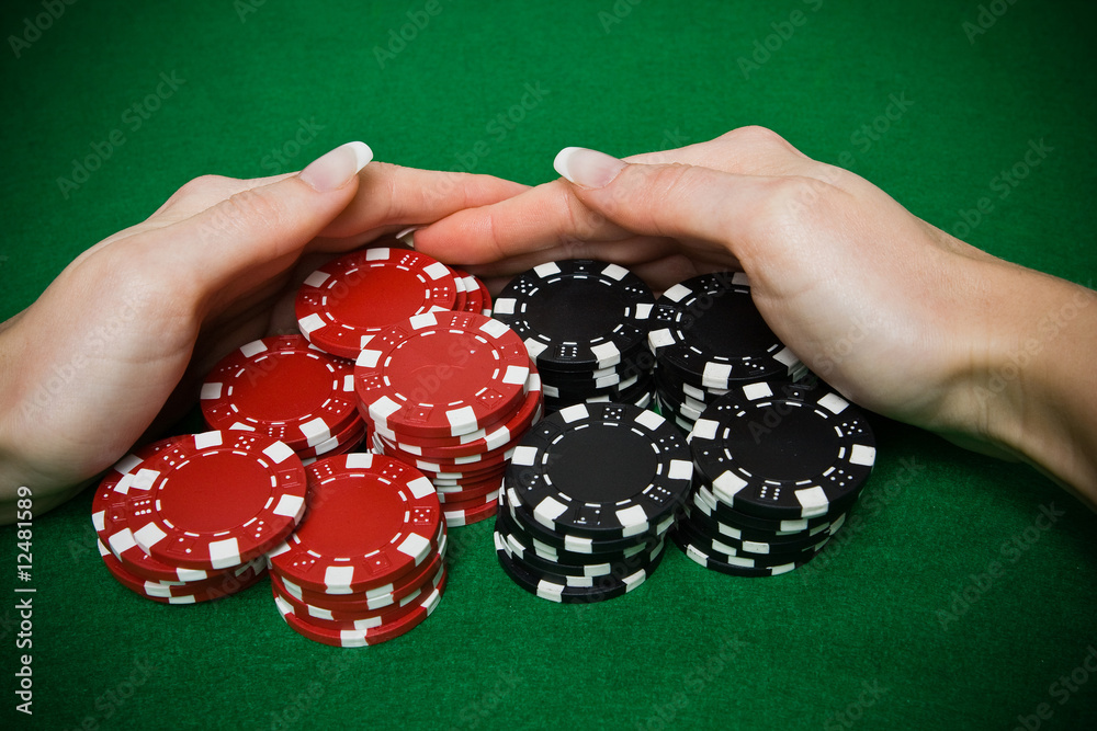 Poker player raking a big pile of chips Poker player raking a big pile of chips