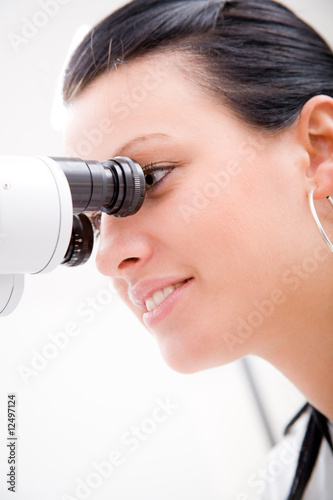 Beautiful young doctor inspect a patient in ophthalmology labor photo