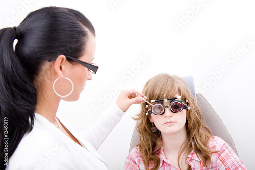 Beautiful young doctor inspect a patient in ophthalmology labor