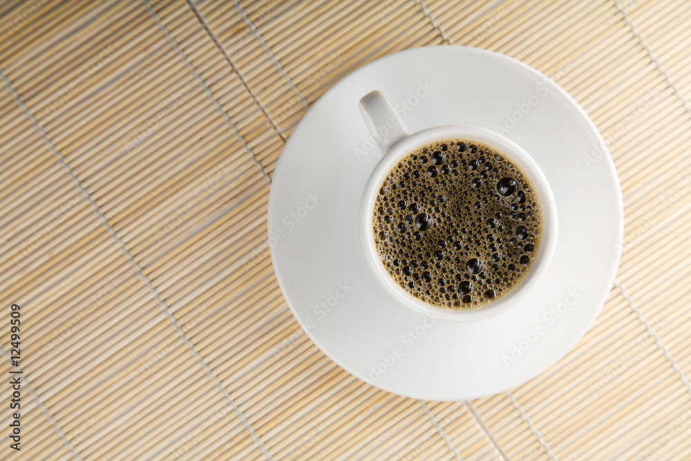 white cup of coffee over bamboo background white cup of coffee over bamboo background