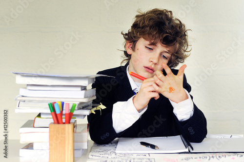 school boy writing on his hand