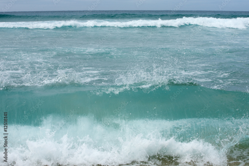 Waves breaking on shore