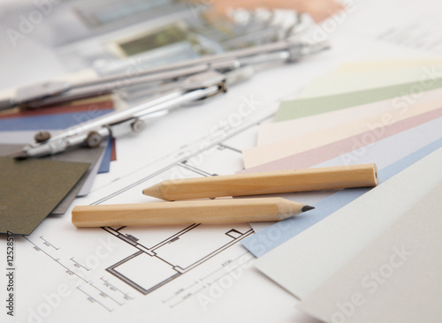 designer's desk with tools, color sample and blueprint. © ping han