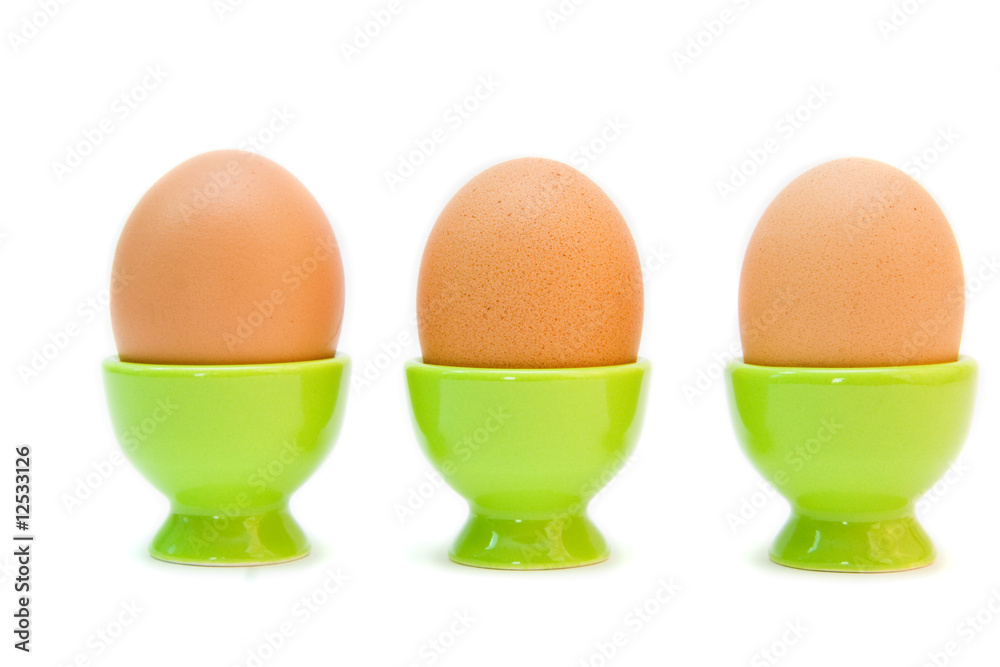 eggs in eggcups isolated on white. easter eggs in eggcups isolated on white. easter