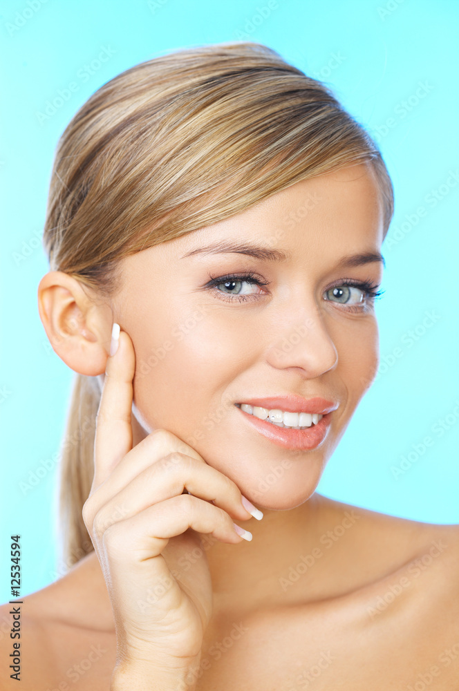 Portrait of 20-25 years old beautiful woman on blue