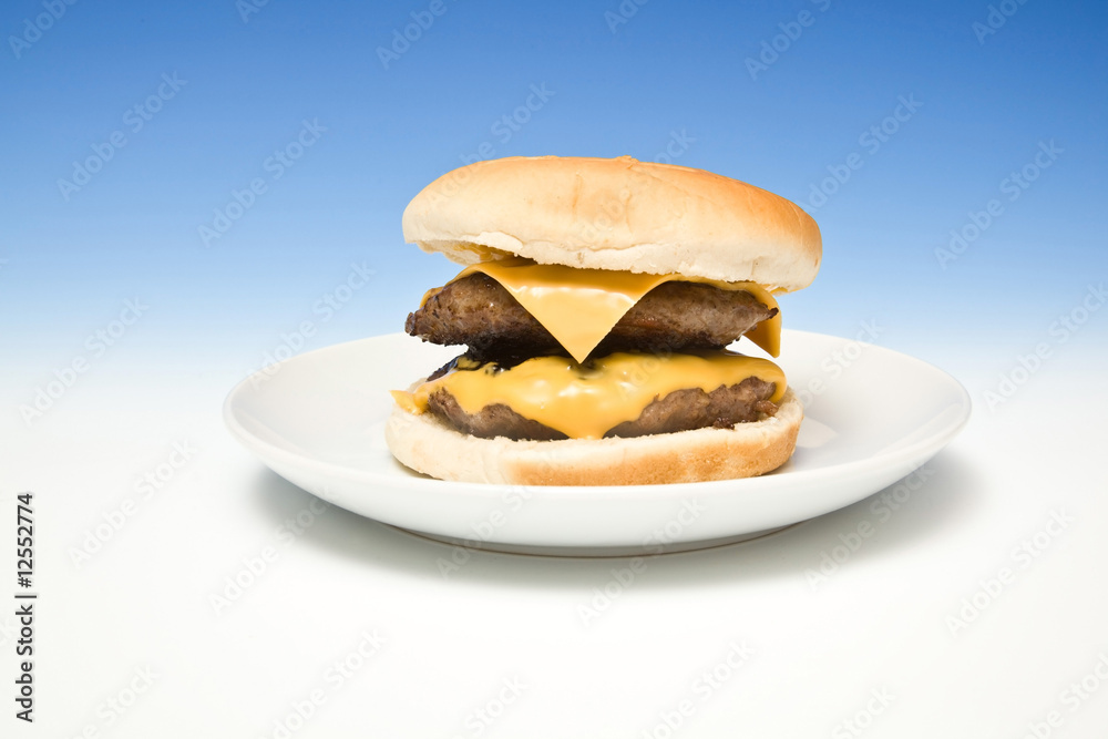 Cheeseburger on a graduated blue studio background.