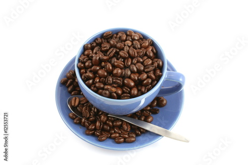 cup full of coffee beans close up isolated in studio