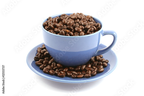 cup full of coffee beans close up isolated in studio