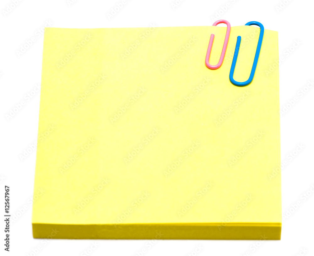 yellow pages of notebook with paper clip on white yellow pages of notebook with paper clip on white