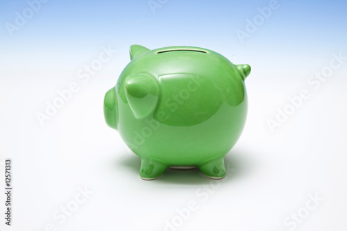 Green piggy bank style money box. photo
