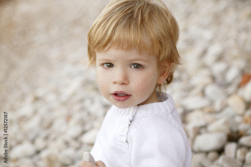 boy portrait winter outdoor, stones background boy portrait winter outdoor, stones background