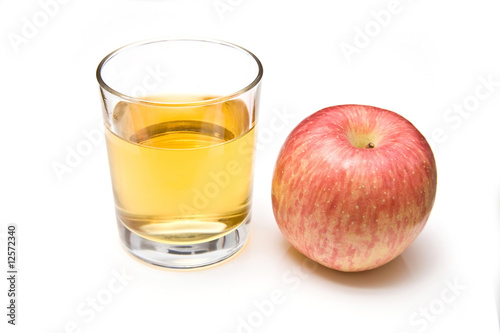 Glass of apple juice with a fuji apple