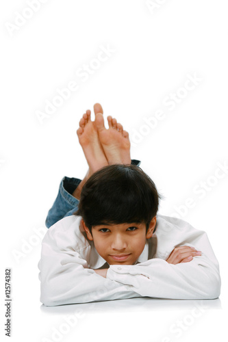 Handsome young teen boy lying on floor photo