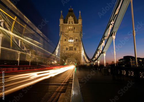 Tower Bridge with motion blur of passing double decker red bus