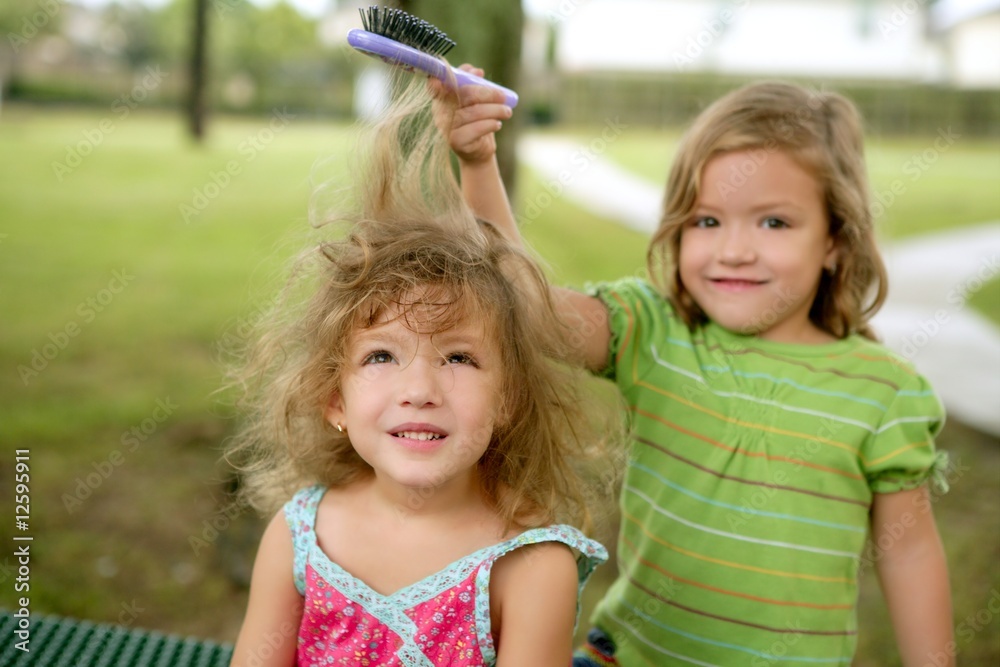 Photography Two twin sisters pretending to be hairdresser