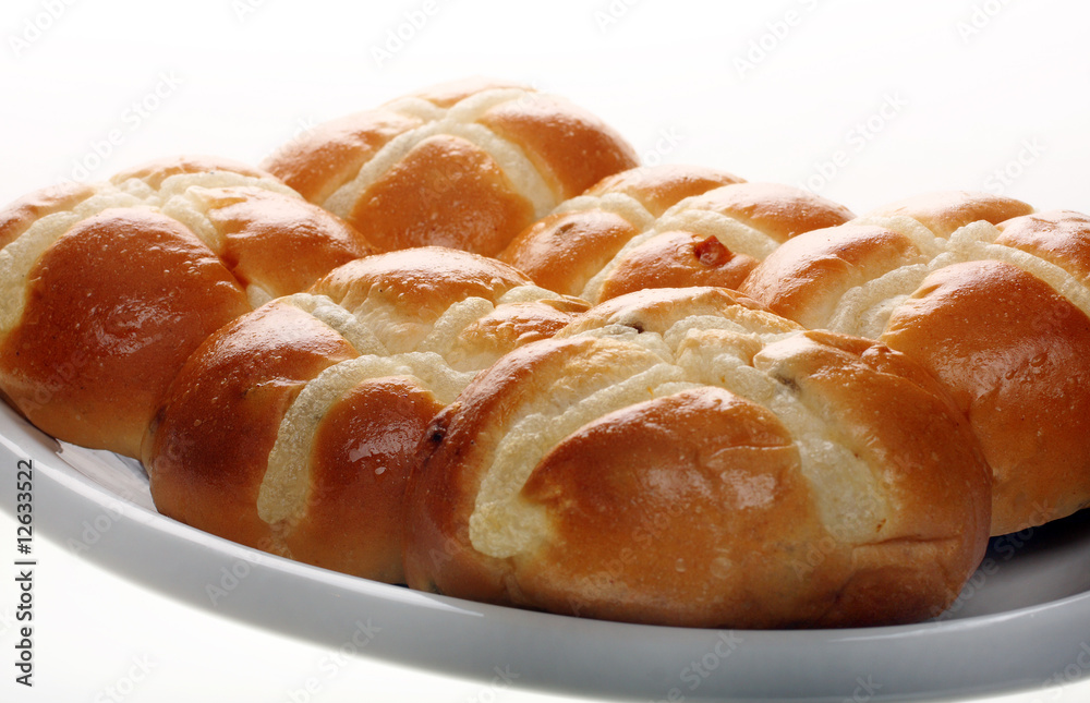 Easter hot cross buns stacked on a flat plate Easter hot cross buns stacked on a flat plate