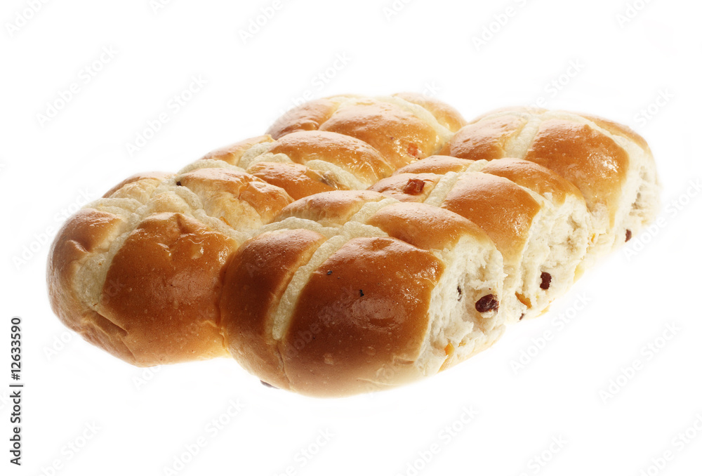 Easter hot cross buns stacked on a flat plate