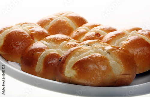 Easter hot cross buns stacked on a flat plate