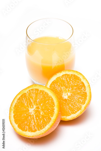 Glass of orange juice with a halved orange