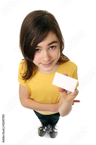 Girl holding blank card, looking up isolated on white