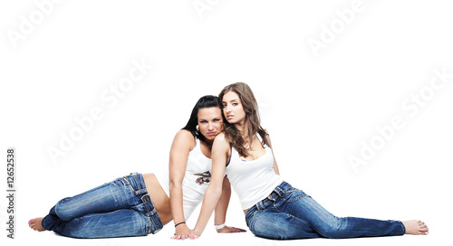 two girlsfriends wearing blue jeans on white