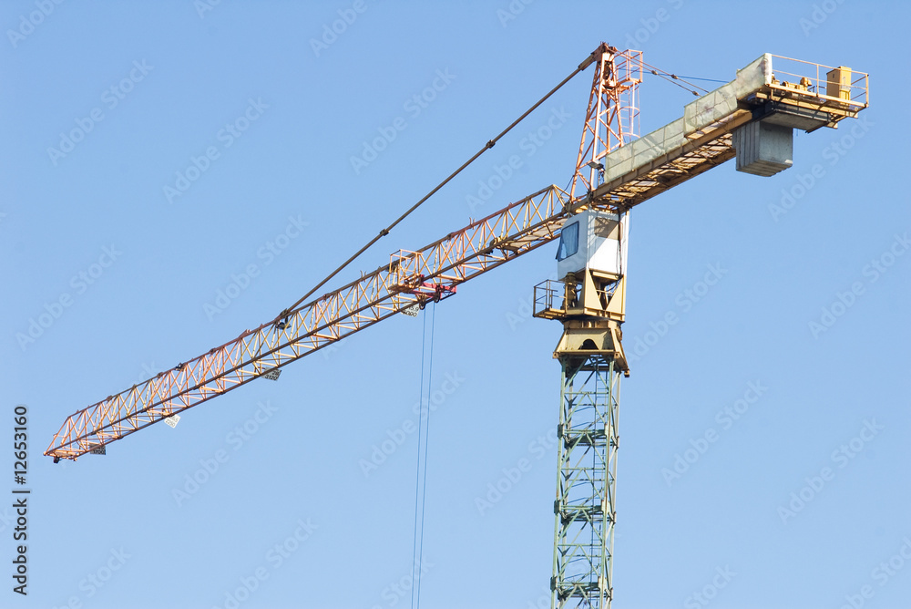 Building tower crane against blue sky