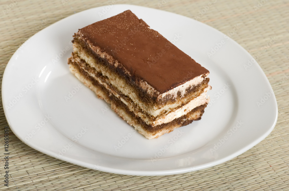 tiramisu on a plate with a bamboo mat tiramisu on a plate with a bamboo mat
