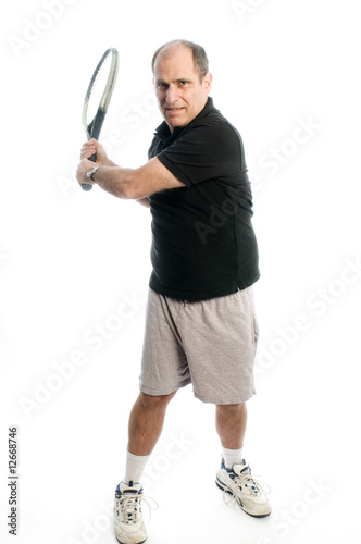 happy middle age man playing tennis back hand © robert lerich