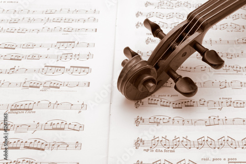 Vintage violin neck resting on a sheet music