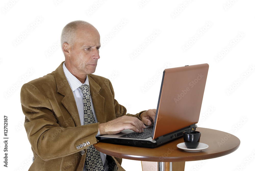 Mature man working in is laptop isolated in white Mature man working in is laptop isolated in white