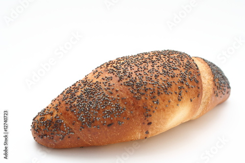 Fresh bun with poppy seed isolated on white
