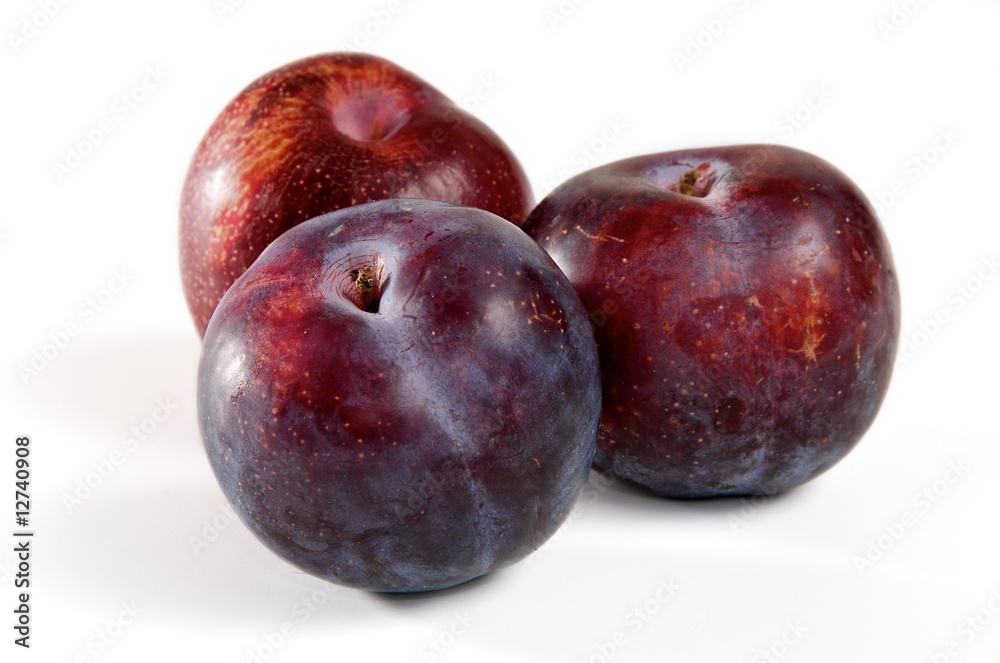 Three red plums on a white background. Three red plums on a white background.