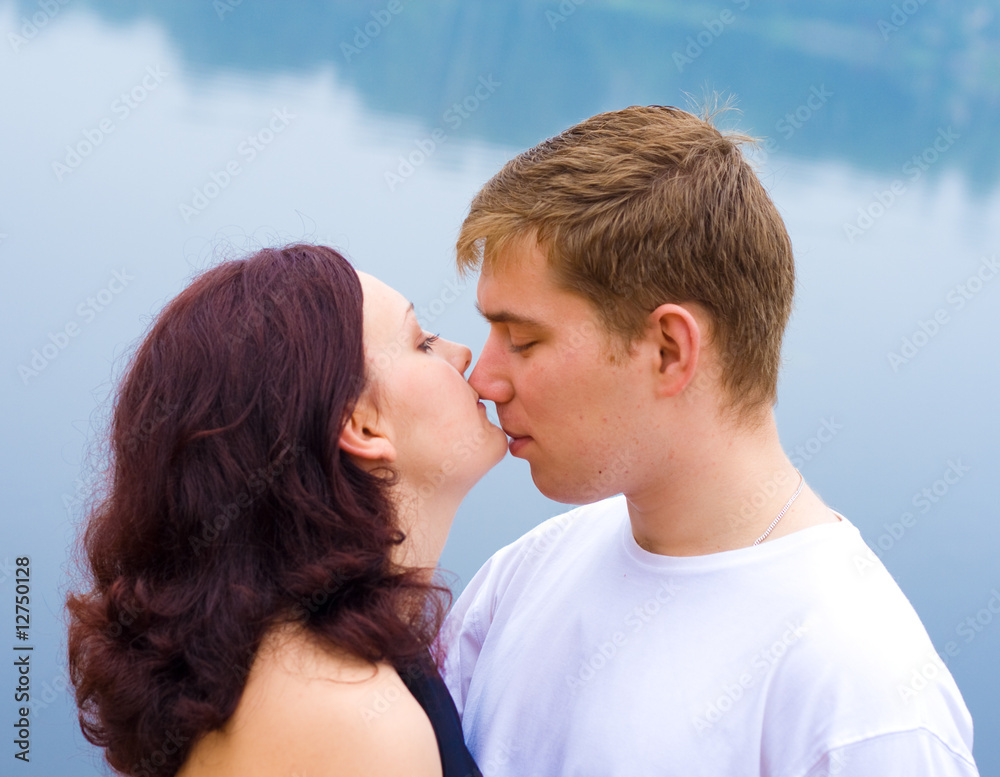 Loving couple kissing at water Loving couple kissing at water