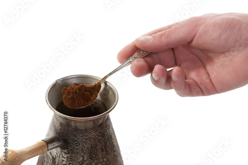 The spoon of ground coffee fallen in a coffee maker