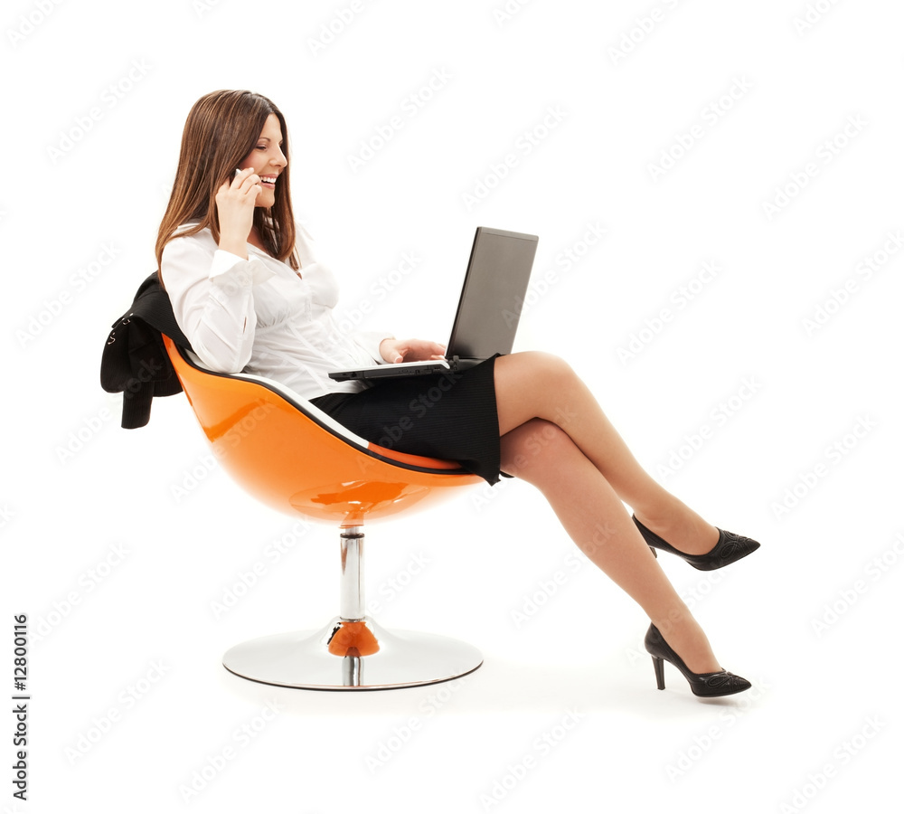 businesswoman in chair with laptop and phone businesswoman in chair with laptop and phone