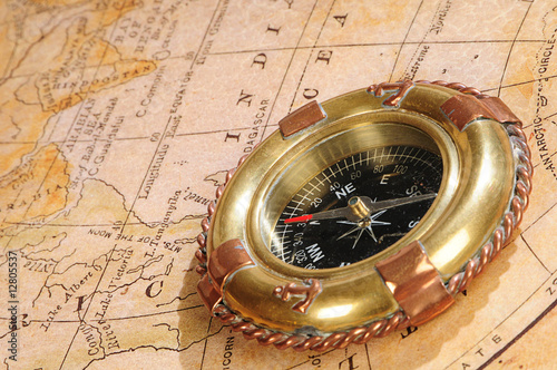 old-fashioned compass on an old map