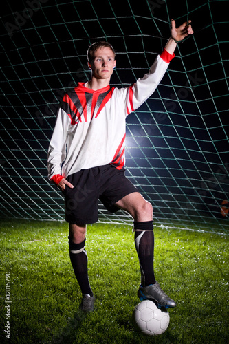 soccer player relaxing in the dark stadium